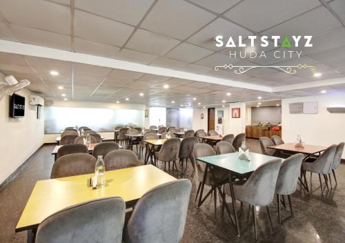 a conference room with tables and chairs in a building at Saltstayz Select - Near Millennium City Centre in Gurgaon