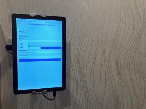 a tablet computer is hooked up to a wall at YOKOHAMA STAY PREMIER in Yokohama