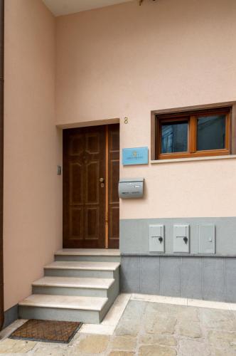 a building with stairs and a door and windows at San Lorenzo B & B in Ruoti