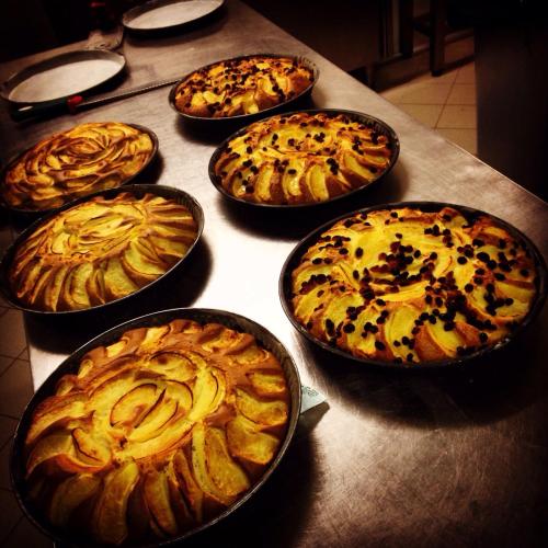 a group of pizzas in pans on a table at TH Borca di Cadore - Park Hotel Des Dolomites in Borca di Cadore