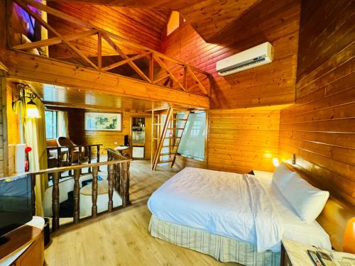 a bedroom with a bed in a wooden cabin at Ivy Motel in Chiayi City