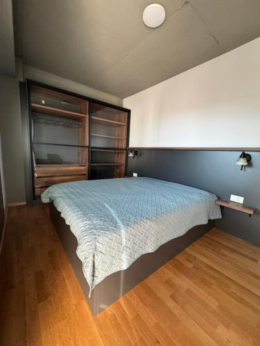 a bedroom with a bed and a wooden floor at Luxury Apartment IVA VI in Skopje