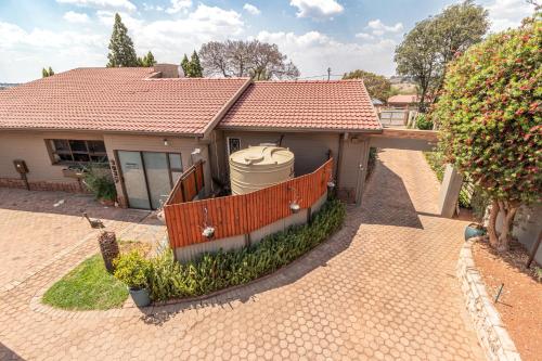 a house with a water tank in front of it at Gold Crest Guesthouse in Roodepoort