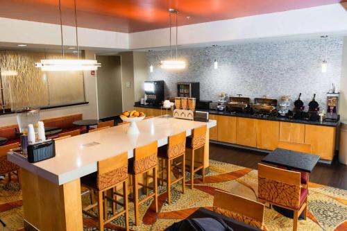 a large kitchen with a large table and chairs at La Quinta by Wyndham Starkville at MSU in Starkville