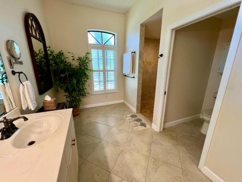 a bathroom with a sink and a shower at Imperial Paradise Naples in Bonita Springs