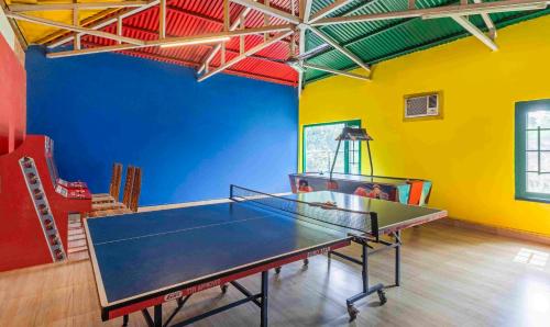 a room with a ping pong table in it at Treebo Tiger Pug Mark Resort with Pool in Rāmnagar