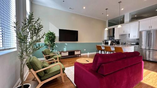 a living room with a red couch and a kitchen at Cozy 1 BR 1 Parking Sleeps 4 in Chicago