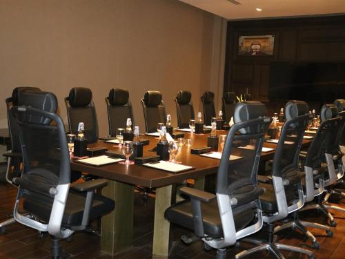 a conference room with a long table and chairs at Welcomhotel by ITC Hotels, Raja Sansi, Amritsar in Amritsar