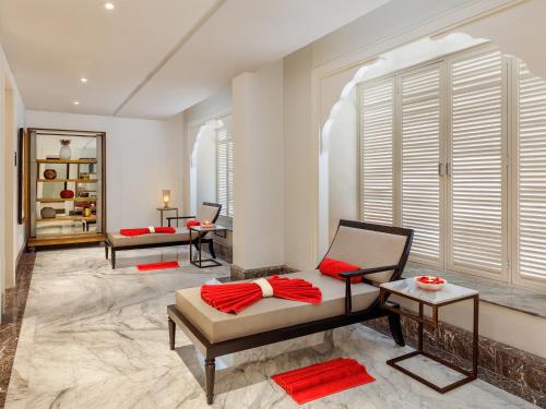 a living room with two chairs and a window at Welcomhotel by ITC Hotels, Raja Sansi, Amritsar in Amritsar