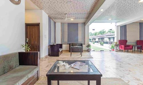 a lobby with a couch and a coffee table at Treebo Tiger Pug Mark Resort with Pool in Rāmnagar