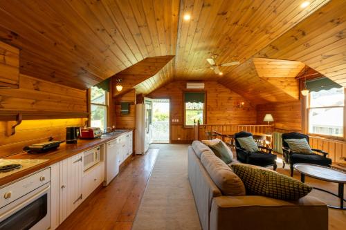 a kitchen and living room with a couch in a cabin at Craignair Cottage in Mount Macedon