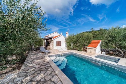 an image of a swimming pool in front of a house at Pool House Potirna - Happy Rentals in Blato