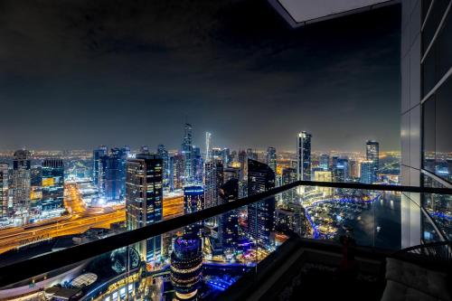 a view of a city skyline at night at Dubai Marina 3BR Penthouse with Stunning JBR, Marina & Dubai Eye Views in Dubai