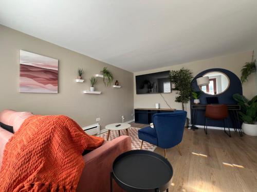 a living room with a couch and a table at Serenity & Style With Parking in Lombard