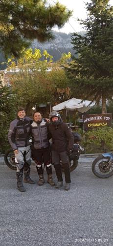 a group of three men standing next to a motorcycle at Archontiko tou Krommyda in Elati Trikalon