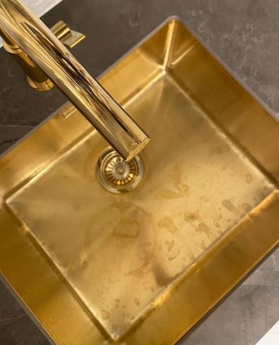 a gold sink with a metal at Luxurious villa - exceptional location in city center with free P in Odense