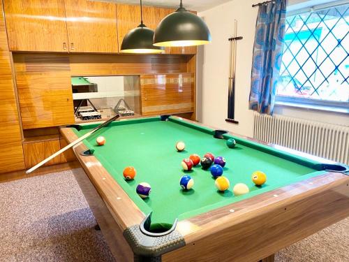 a room with a pool table with balls on it at Forestside Raceway Hideaway in Oberweg
