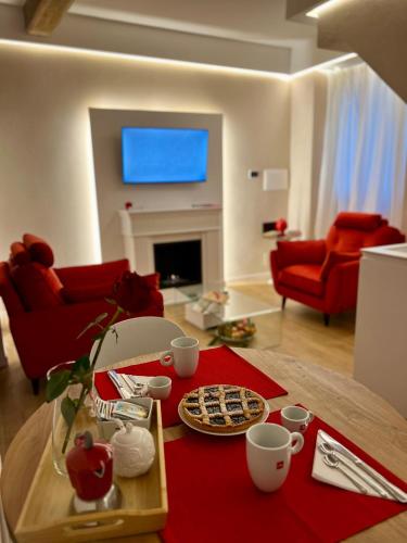 a living room with a table with a tray of food at Elena's Suite in Sutri