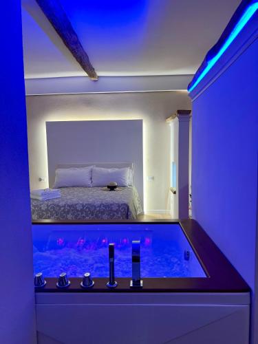 a hotel room with a bed and a blue light at Elena's Suite in Sutri