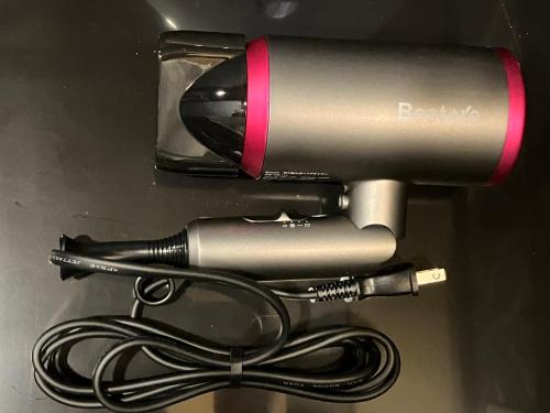 a hair dryer and a blow dryer with a cord at Hanamachi guest house in Osaka