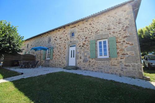 a stone building with a yard in front of it at Gîte Les Champs N°2 in Saint-Mathieu