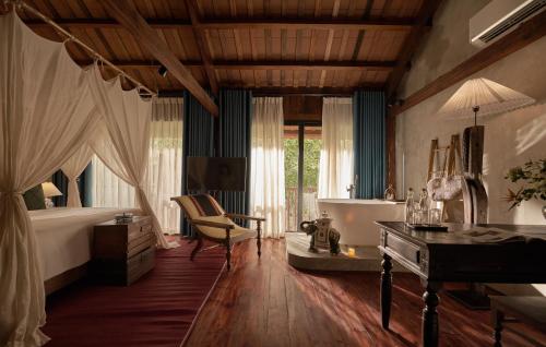 a bedroom with a bed and a desk and a chair at aNhill Boutique in Hue