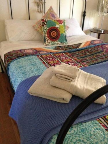 two twin beds with towels and pillows on them at Picture Perfect Toorak, entire apartment in Melbourne