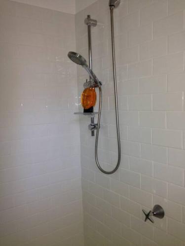 a shower with a shower head in a bathroom at Picture Perfect Toorak, entire apartment in Melbourne