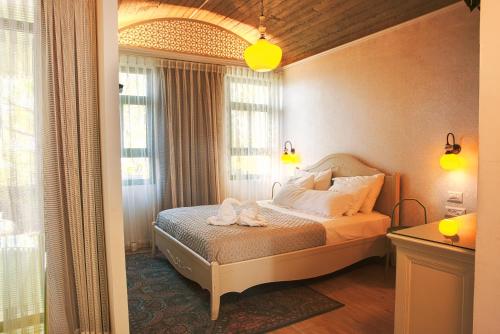 Postel nebo postele na pokoji v ubytování Neve Shalom Hotel