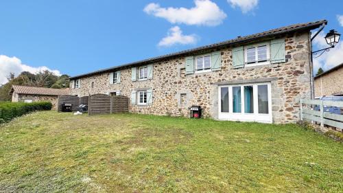 a brick house with a yard in front of it at Gîte Les Champs N°3 in Saint-Mathieu