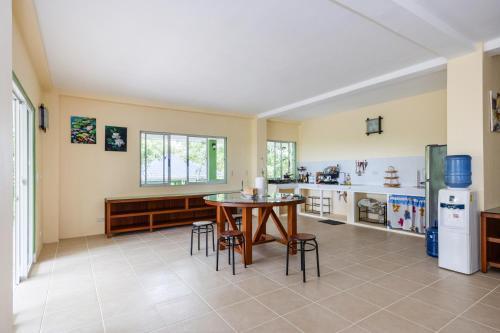 a kitchen with a table and chairs in a room at Villa Jolam - Family haven in an island paradise in Camotes Islands