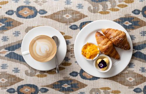 a plate of eggs and toast and a cup of coffee at The Cellars-Hohenort in Cape Town