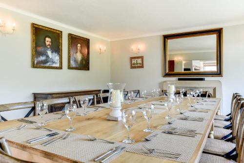 a long table with glasses and silverware on it at Oldfield house, walking distance of pub & sea in West Itchenor