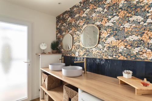 La salle de bains est pourvue de 2 lavabos et de 2 miroirs sur le mur. dans l'établissement Le Ty Sillon - Appt proche de la plage, à Saint-Malo