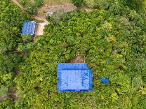 an overhead view of a blue building in the forest at Villa Jolam - Family haven in an island paradise in Camotes Islands
