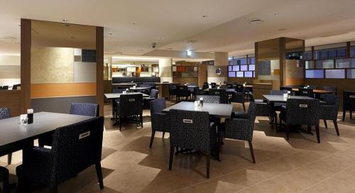 a dining room with tables and chairs in a restaurant at Akasaka Excel Hotel Tokyu in Tokyo