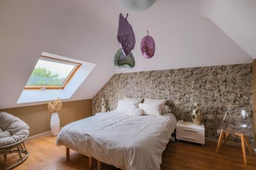 a bedroom with a bed in a room with a window at Le Logis de La Baule - Maison climatisée piscine in La Baule