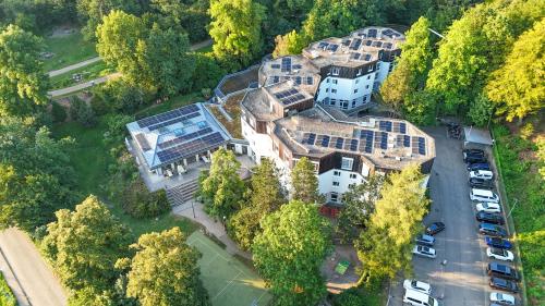 an overhead view of a large house with a parking lot at Jugendherberge Freiburg in Freiburg im Breisgau