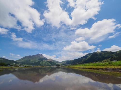 a view of a river with mountains in the background at Secret Base Tokinokakera in Yufuin