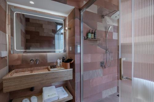 a bathroom with a sink and a shower at Vretreats Suyunjian Boutique Hotel in Xinglong