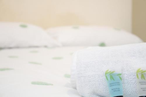 a close up of a bed with towels on it at Centrally located double rooms in Southampton