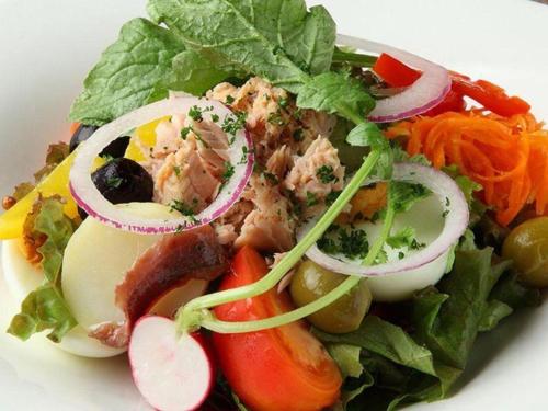 a salad with meat and vegetables on a white plate at Nippondaira Hotel in Shizuoka