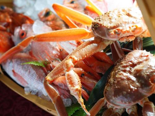 a plate of food with lobster and other seafood at Centrale Hotel Kyotango in Kyotango