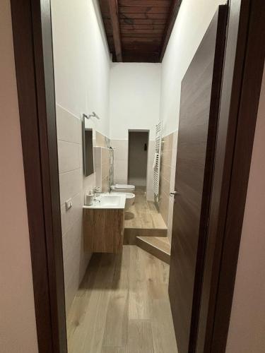 a bathroom with two sinks and two toilets at CG HOME City Centre in Cosenza