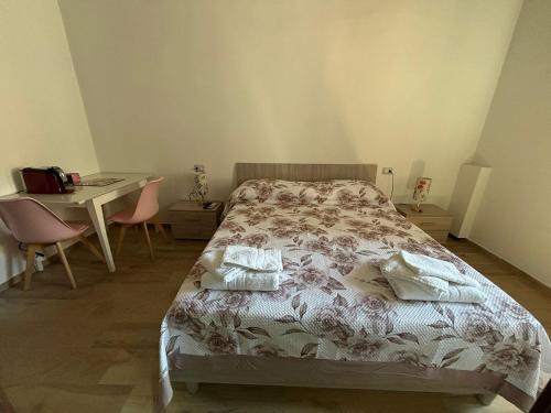 a bedroom with a bed and a table and a desk at CG HOME City Centre in Cosenza