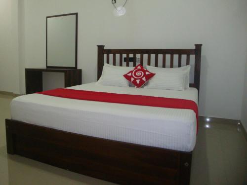 a bedroom with a large bed with a mirror at Sea View Tourist Inn in Tangalle