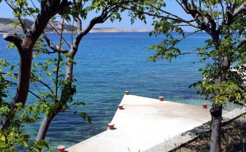a dock in the middle of a body of water at Apartment Per in Stara Novalja