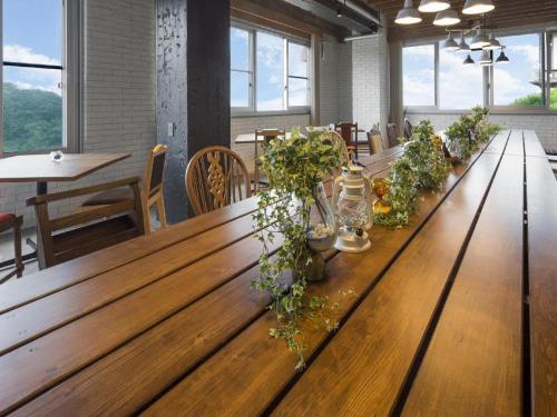 a long wooden table with potted plants on it at MISAKI TERRACE in Ako