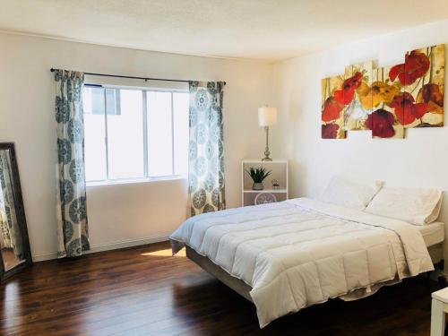 a bedroom with a large bed and a window at Coastal Comfort Homestay in Santa Monica in Los Angeles
