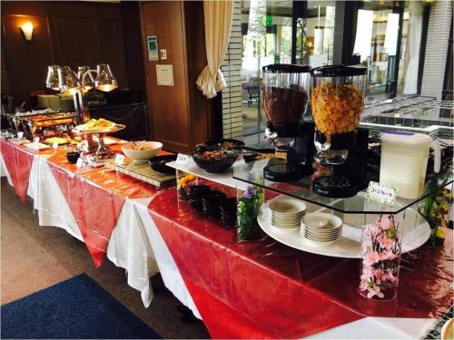 a buffet line with food on a red table at HOTEL WINDSOR in Nakatsugawa